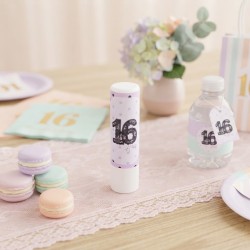 Bálsamo labial en barra Coquette con diseño de lazos y tonos pastel.